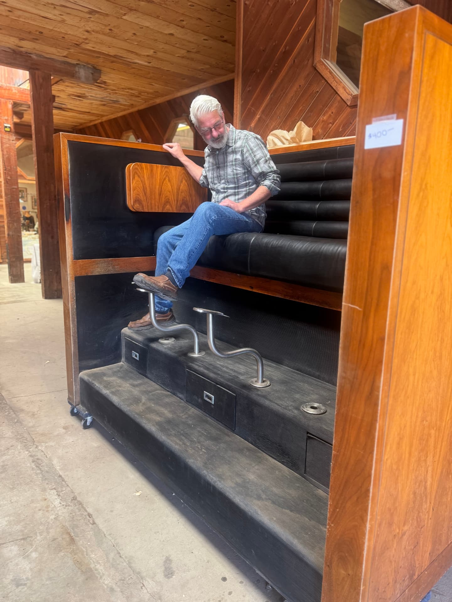 A visitor trying out a vintage shoeshine stand inside the Fruit Exchange Building.