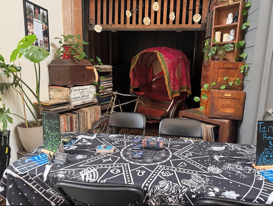 A tarot reading booth set up with vintage records and antiques at the Bazaar.